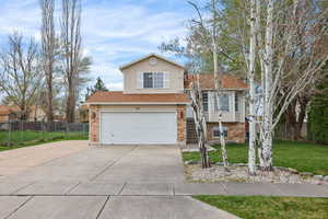 Charming curb appeal framed by mature aspen trees—Utah’s state tree—creating a welcoming, distinctly local first impression.