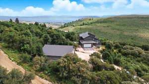 Aerial view of property and surrounding area with mountains