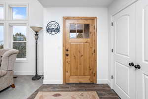 Foyer with wood finish floors and baseboards