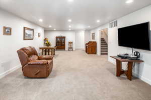 Living area featuring recessed lighting and light colored carpet
