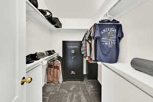 Walk in closet featuring dark carpet