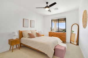 Bedroom featuring ceiling fan and light colored carpet