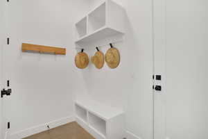Mudroom with baseboards and concrete floors