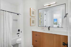 Full bath featuring vanity and shower / tub combo