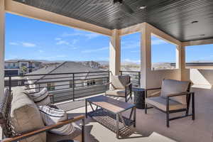 View of patio featuring a ceiling fan, an outdoor living space, and a residential view