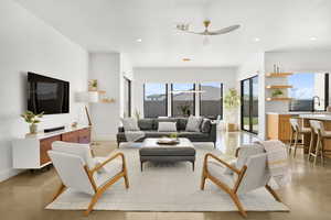 Living area featuring finished concrete floors, recessed lighting, and ceiling fan