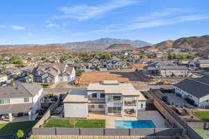 Aerial perspective of suburban area with a mountainous background and a pool area