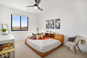 Bedroom with ceiling fan and light carpet