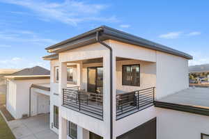Rear view of property featuring stucco siding and a patio