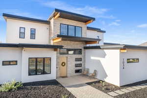 View of front facade with stone siding and stucco siding