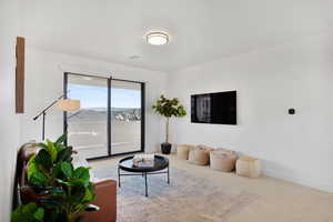 Carpeted living area featuring baseboards