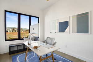 Office space featuring finished concrete floors and a residential view