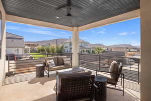 View of patio / terrace with ceiling fan, an outdoor hangout area, a mountain view, and a residential view