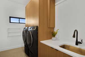 Laundry area featuring concrete floors and separate washer and dryer