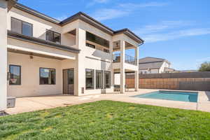 Back of property with stucco siding, a patio, and a balcony
