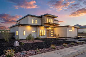 Modern home featuring stone siding and stucco siding