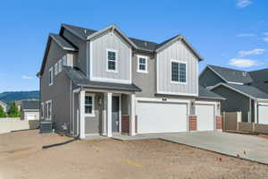 Contemporary two-story residence with a gray stucco facade and light gray vertical siding accents