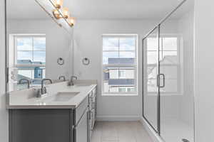 Dual vanity with a light-toned countertop, under-mount sinks, and brushed nickel faucets