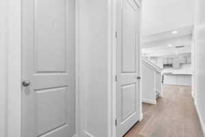 Hallway featuring wood-finish flooring and recessed lighting