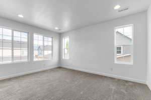 Spacious room with light gray carpet and white walls