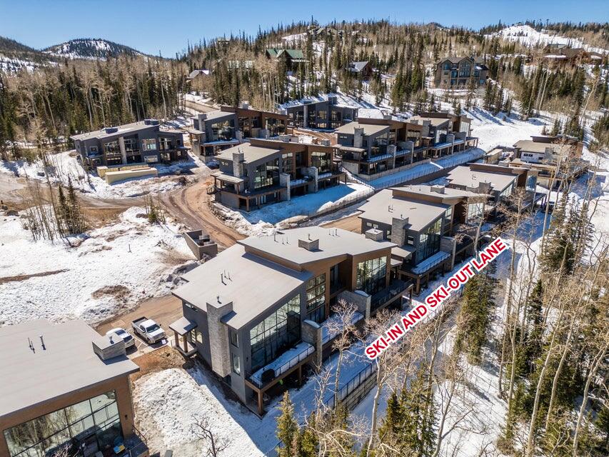 Modern mountain community featuring multiple residences with large windows and balconies