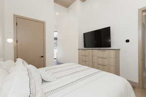 Primary bedroom with recessed lighting, wood finished floors, built-in dressers and a high wood ceiling