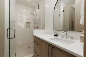 En-suite bathroom featuring vanity and a stall shower