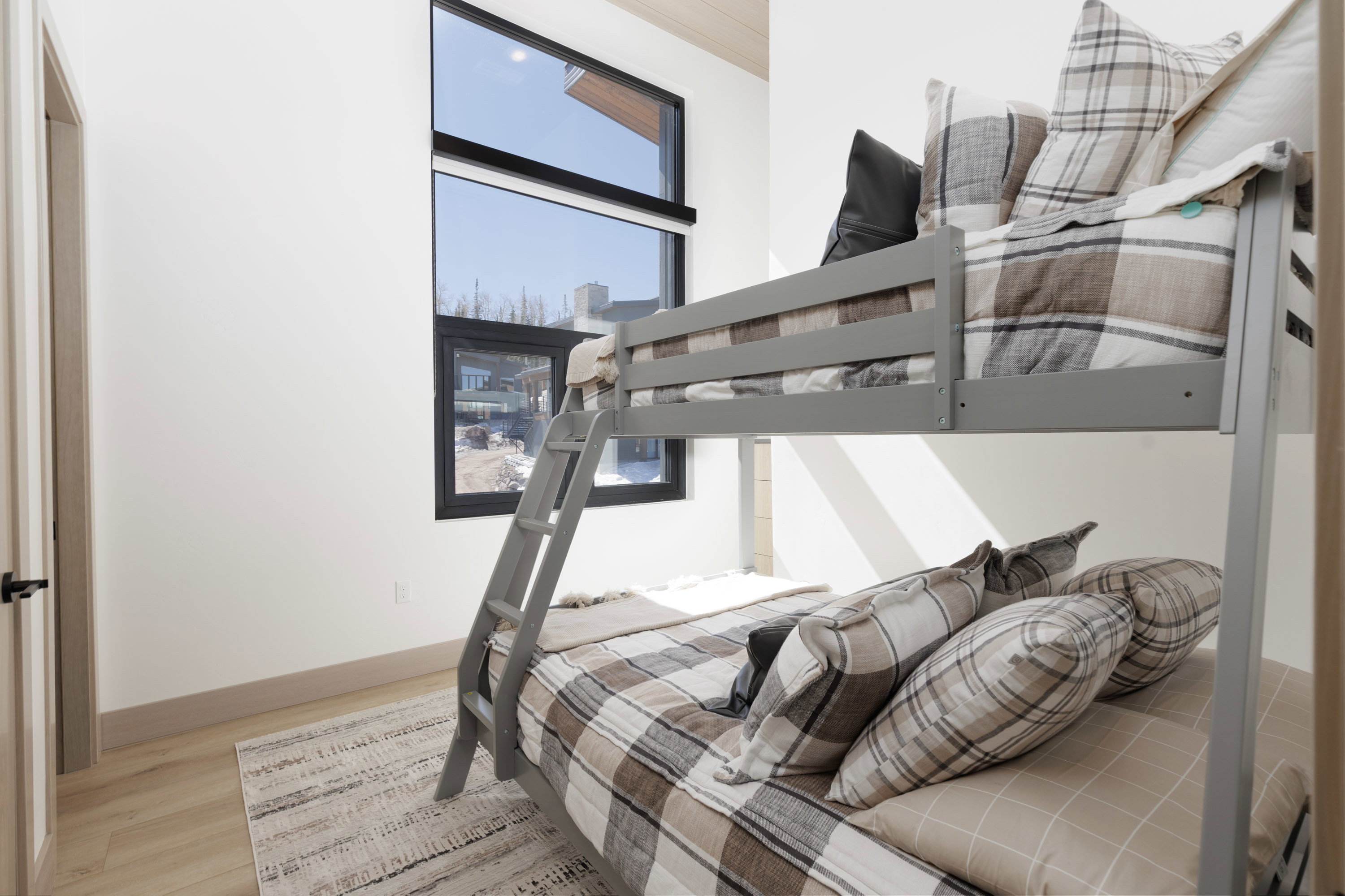 Bedroom featuring en-suite bathroom, and light wood-type flooring