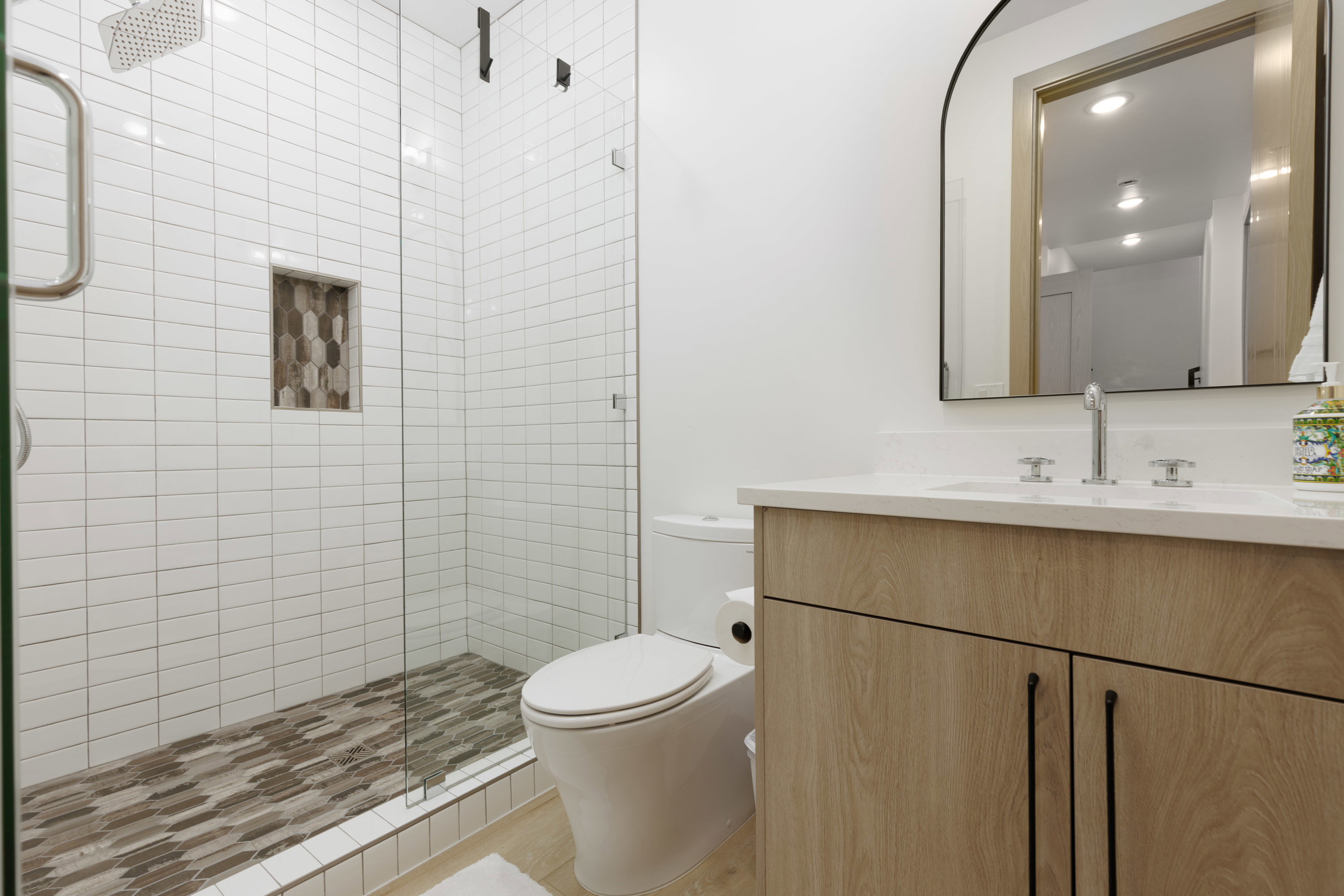 En-suite bathroom featuring vanity and a stall shower