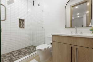 En-suite bathroom featuring vanity and a stall shower