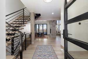 Entryway with light wood-style flooring and recessed lighting
