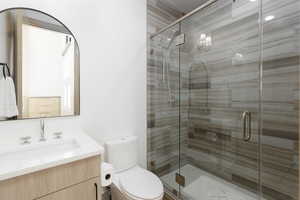 En-suite bathroom featuring vanity and a stall shower