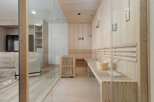 Relaxing sauna / steam room featuring wood-type flooring and wood ceiling