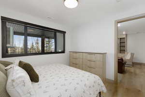 Bedroom with light wood-style flooring and recessed lighting