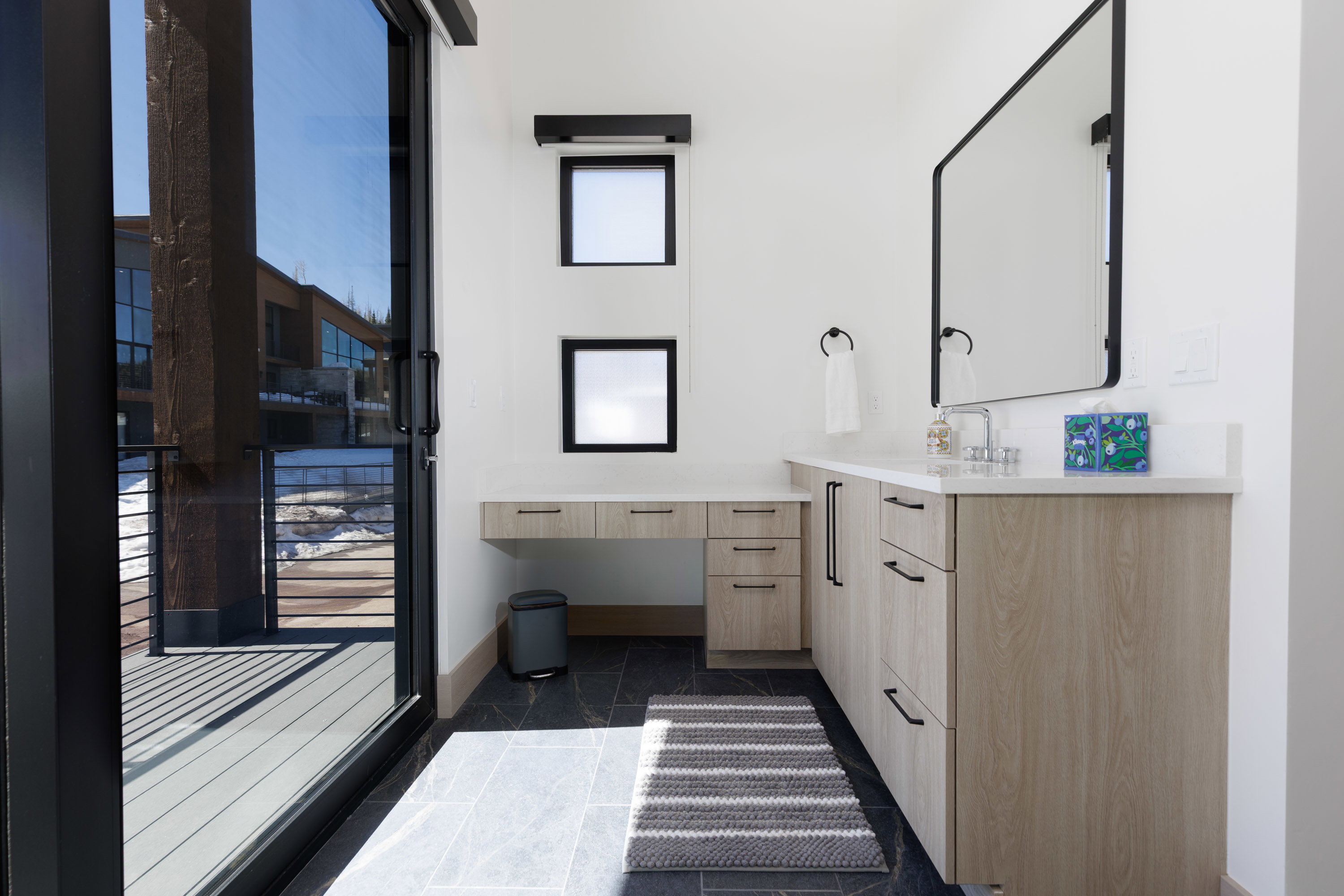 Primary bathroom with vanity and baseboards