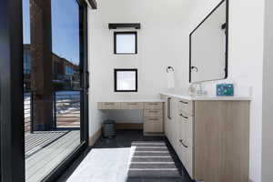 Primary bathroom with vanity and baseboards