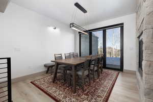 Dining space featuring light wood finished floors and a fireplace