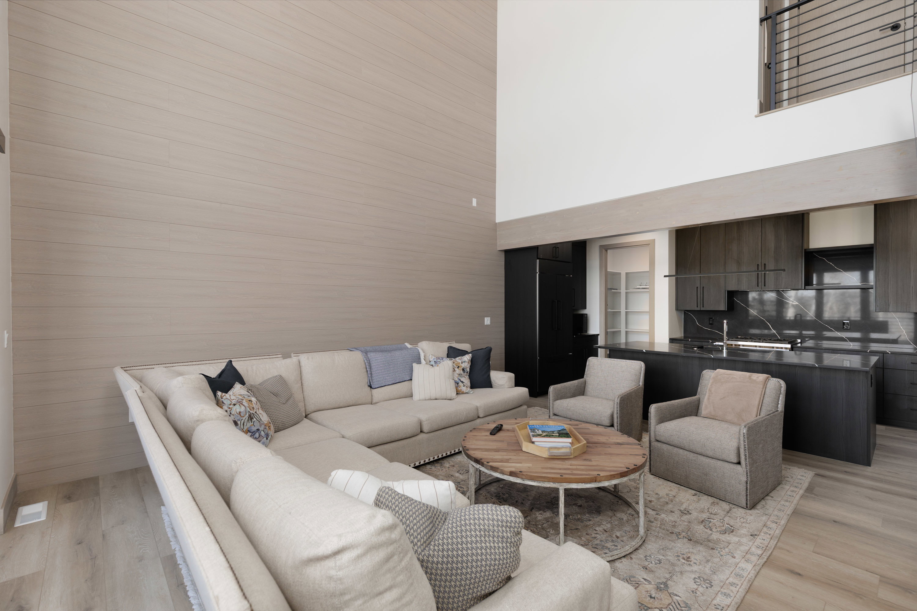 Living area featuring a high ceiling and light wood-style floors