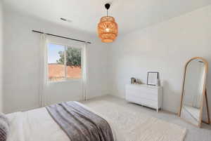 Bedroom featuring light carpet and baseboards