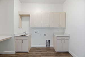Laundry room featuring washer hookup, hookup for an electric dryer, dark wood-type flooring, and cabinet space