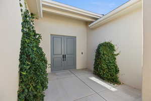 Doorway to property with stucco siding