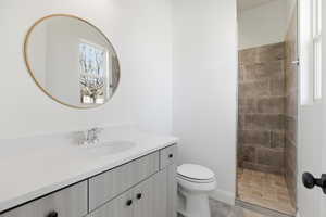 Full bathroom featuring vanity, walk in shower, and light tile patterned floors