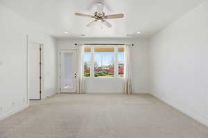 Spare room with a ceiling fan, light carpet, and recessed lighting