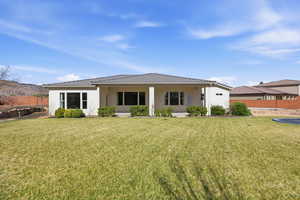 Rear view of property with a tile roof, stucco siding, and covered porch