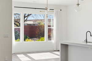 Unfurnished dining area featuring baseboards and light wood finished floors