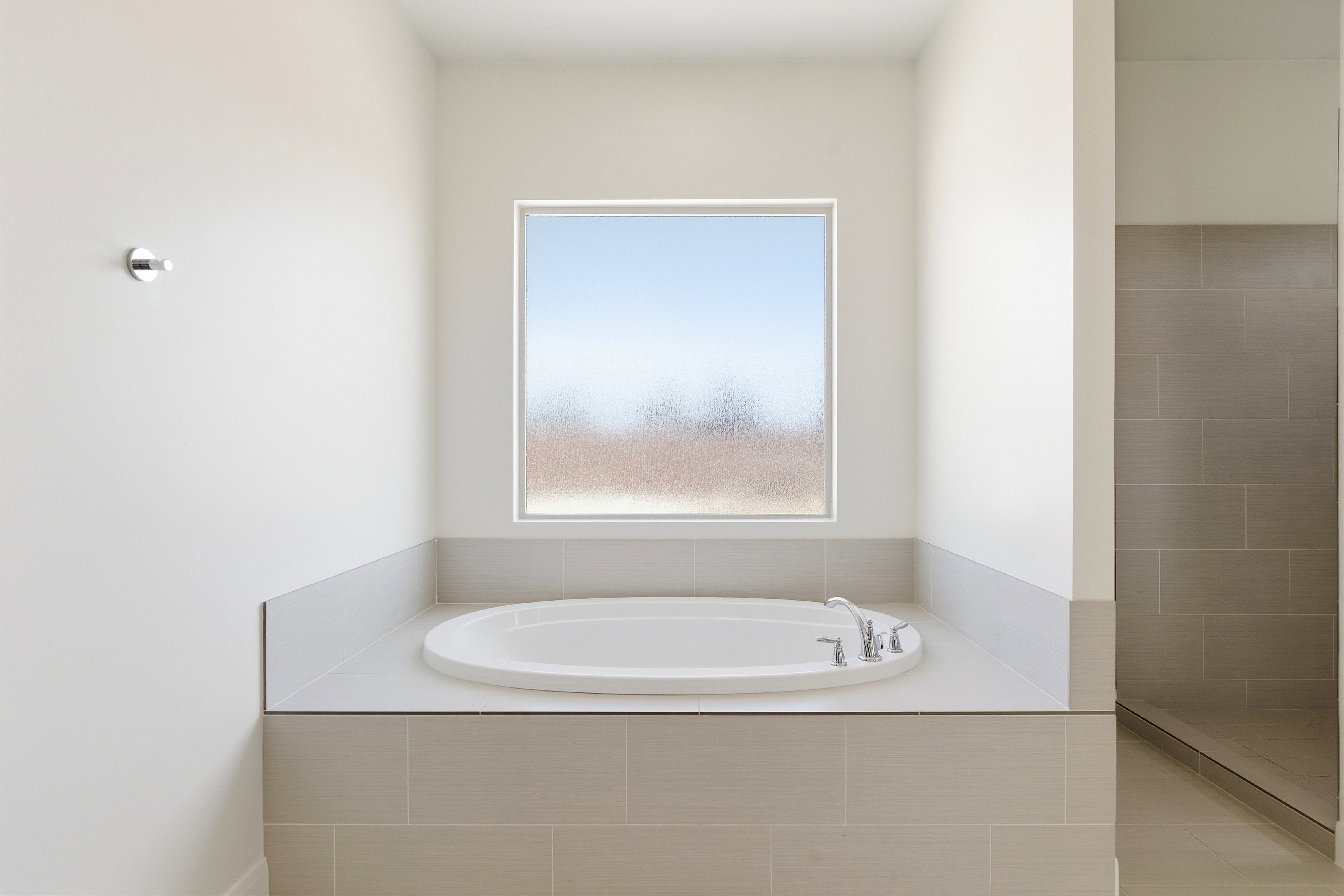 Full bath with a garden tub and tiled shower