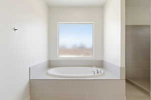 Full bath with a garden tub and tiled shower