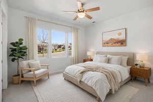 Bedroom featuring a ceiling fan and light carpet