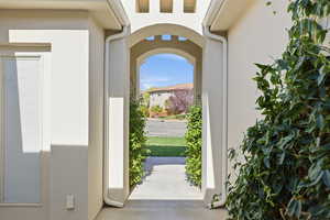 Entryway featuring arched walkways and concrete floors