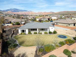 Rear view of house featuring a residential view, stucco siding, and a mountain view